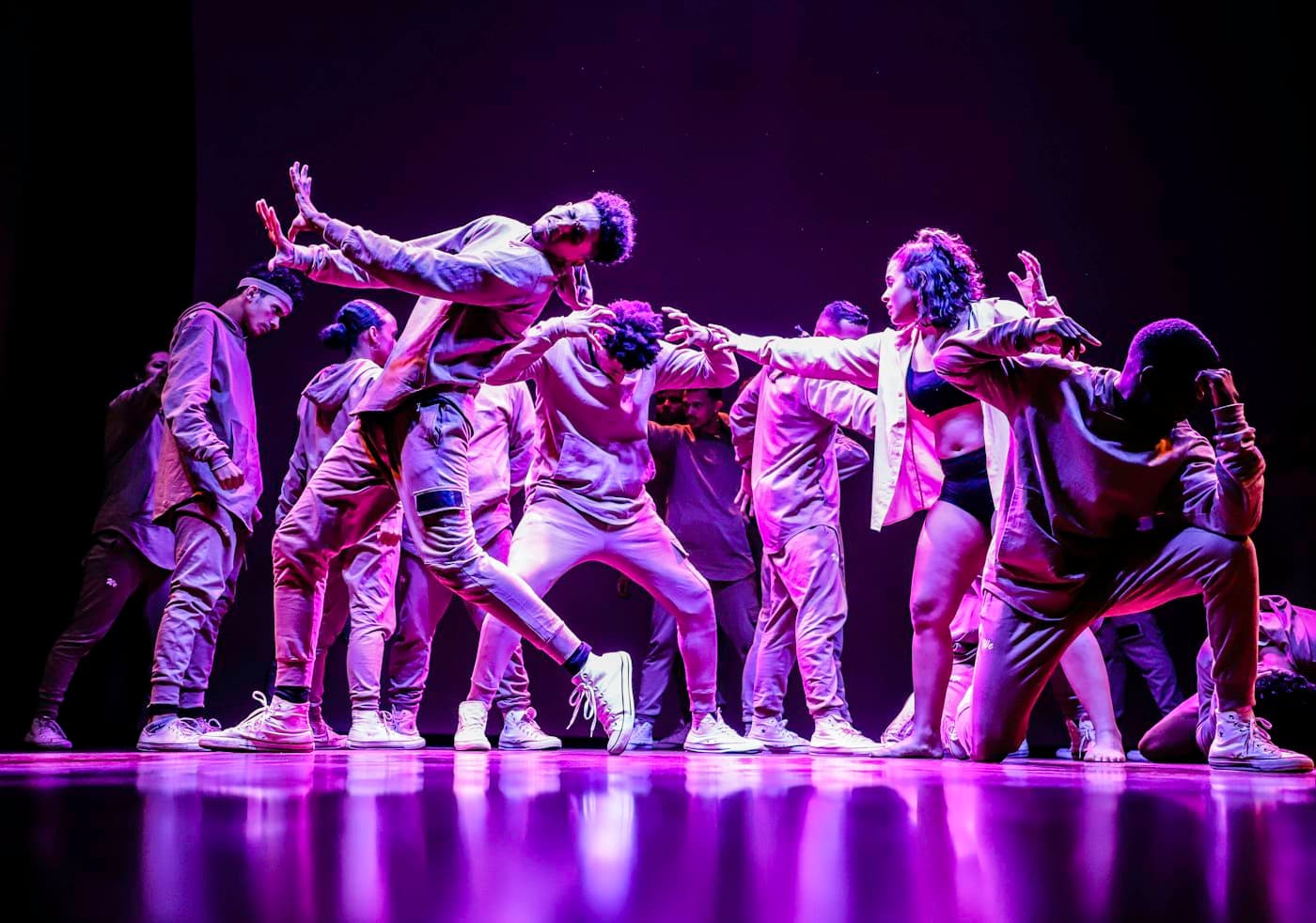Dance crew performing on a lit stage